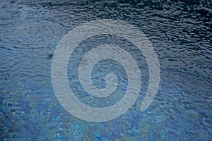 Circle water ripple wave surface background. Rain drop on swimming pool, blue background