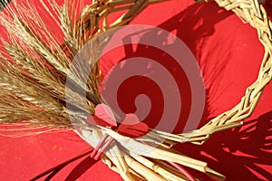 Circle wreath a bundle of wheat with two red paper hearts, valentine day, love and romance, prophecy