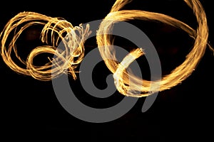 Circles of flames in dark. Fire show on long camera shutter speed. Flames