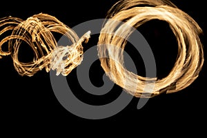 Circles of flames in dark. Fire show on long camera shutter speed. Flames