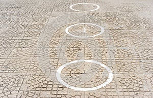 Circles on the ground for social distancing in a queue