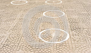 Circles on the ground for social distancing in a queue
