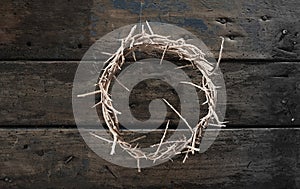 Circlet or crown of thorns on rustic wood