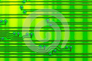 Circuit board as an abstract background, shot with backlight on the lumen. Yellow-green shades