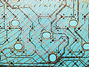 Circuit board made of plastic with circuit traces on blue background. The concept of technology, computing, electronics