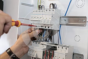 Circuit breaker installation. A technician plugs the cables into the circuit breaker