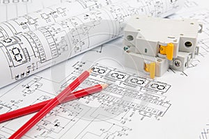 Circuit breaker and pencils on paper electrical engineering drawings