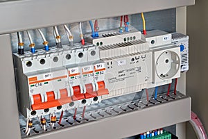 Circuit breakers, control relay, socket and thermostat in electrical Cabinet.