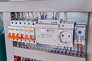 Circuit breakers, thermostat, power supply, socket in electrical Cabinet