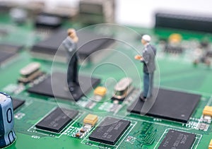 Circuit electric board, two man standing on the chip