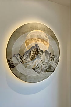 Circular artwork depicts a stylized mountain landscape framed by a glowing ring of light.