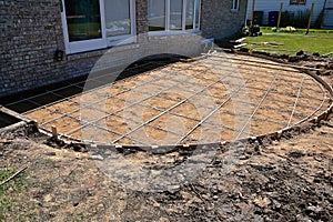 A circular backyard patio is ready for concrete as the forms and connecting rods are in place,