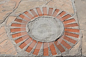 Circular brick pattern on a sidewalk