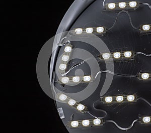 Circular button lights in a disc covered with spider web against dark background