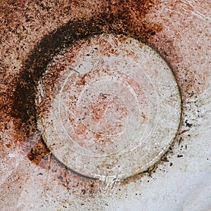 Circular circle rust spot on an iron plate. Abstract, minimalist color photo.