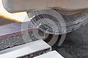 The circular diamond saw cuts concrete paving slabs. Concrete cutting machine close-up