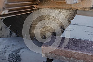 The circular diamond saw cuts concrete paving slabs. Concrete cutting machine close-up