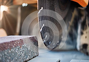 The circular diamond saw cuts concrete paving slabs. Concrete cutting machine close-up