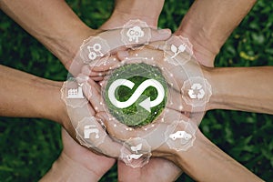 Circular economy concept.Group of poeple holding to wolrd.The concept of eternity, endless and unlimited, circular economy for