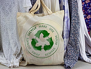 Circular Economy Textiles on fabric bag make, use, reuse, swap, donate, recycle with eco clothes recycle icon sustainable fashion