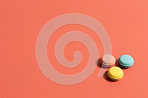 Circular erasers in pink blue and yellow colors on a coral table photo