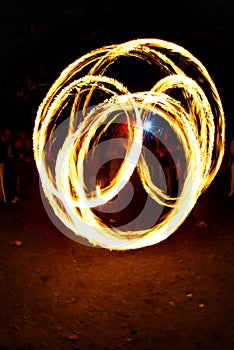 Circular fire trails from a fire juggler