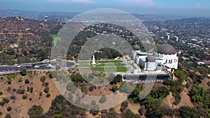 A circular flight over the Griffith Observatory in Los Angeles, California. the silhouette of Los Angeles is visible in