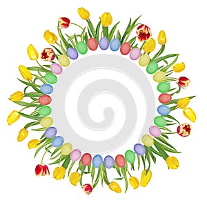 Circular floral frame made of beautiful red and yellow tulips and colorful easter eggs. Isolated on white background.