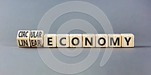 Circular or linear economy symbol. Concept words Circular economy or Linear economy on blocks. Beautiful grey table grey