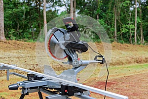 Circular miter saw on a saw stand with under construction a new home