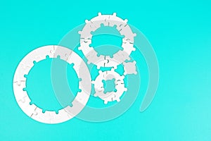 Circular Puzzle Pieces Geared on Blue Background