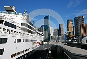 Circular Quay cityscape in Sydney CBD. Cruise ship moored at passenger terminal in Rocks. Iconic skyline of downtown.