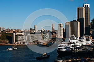 Circular Quay cityscape in Sydney Harbor. Cruise ship at passenger terminal in Rocks. City waterfront. Iconic skyline of downtown.