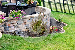 Circular raised brick patio in a formal green lawn