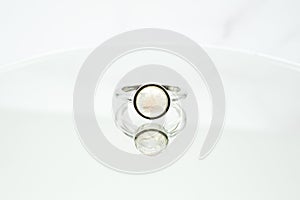 Circular ring made of rainbow moonstone on a white surface