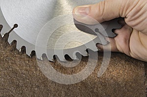 Circular saw blade for wood work on the stone background.