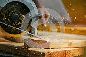 Circular Saw. Carpenter Using Circular Saw for wood beam photo