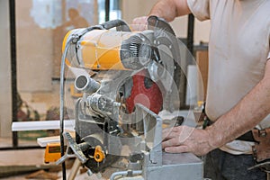 Circular saw cutting new baseboard for renovation home