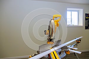 Circular saw cutting new baseboard for renovation home