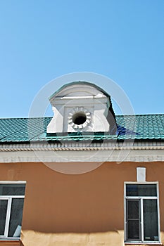 The circular skylight is covered with metal green tiles