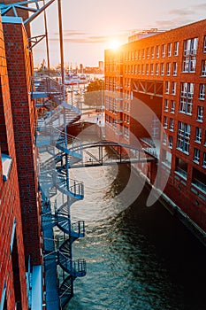 Circular staircase, bridge over canal and red brick buildings in the old warehouse district Speicherstadt in Hamburg in