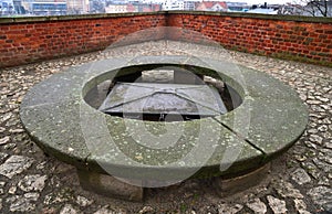 Circular stone bench around metal hatch on observation deck in Wawel Royal Castle,  Krakow, Poland