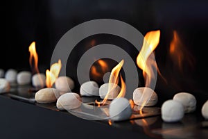 Circular stones and flames in fireplace