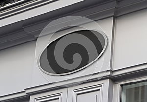 Circular storefront on a grey shop frontage Mockup. Empty store brand signboard frame in street