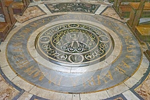 Circular tomb in the floor of the church of Santa Agnese in Agone located in Piazza Navona, Rome, Italy photo