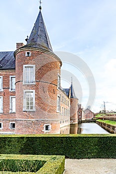 Circular tower of 16th century Alden Biesen castle surrounded by the moat