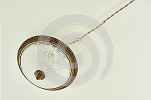 Circular vintage plafond lamp with electrical wiring. Background, copy space