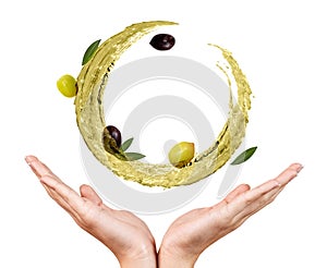 Circulate splash of olive oil with olives in female hands.