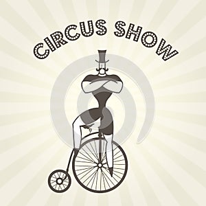 Circus actor on retro bicycle - strongman on old penny farthing