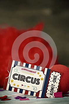 Circus admission ticket, clown nose and red wig